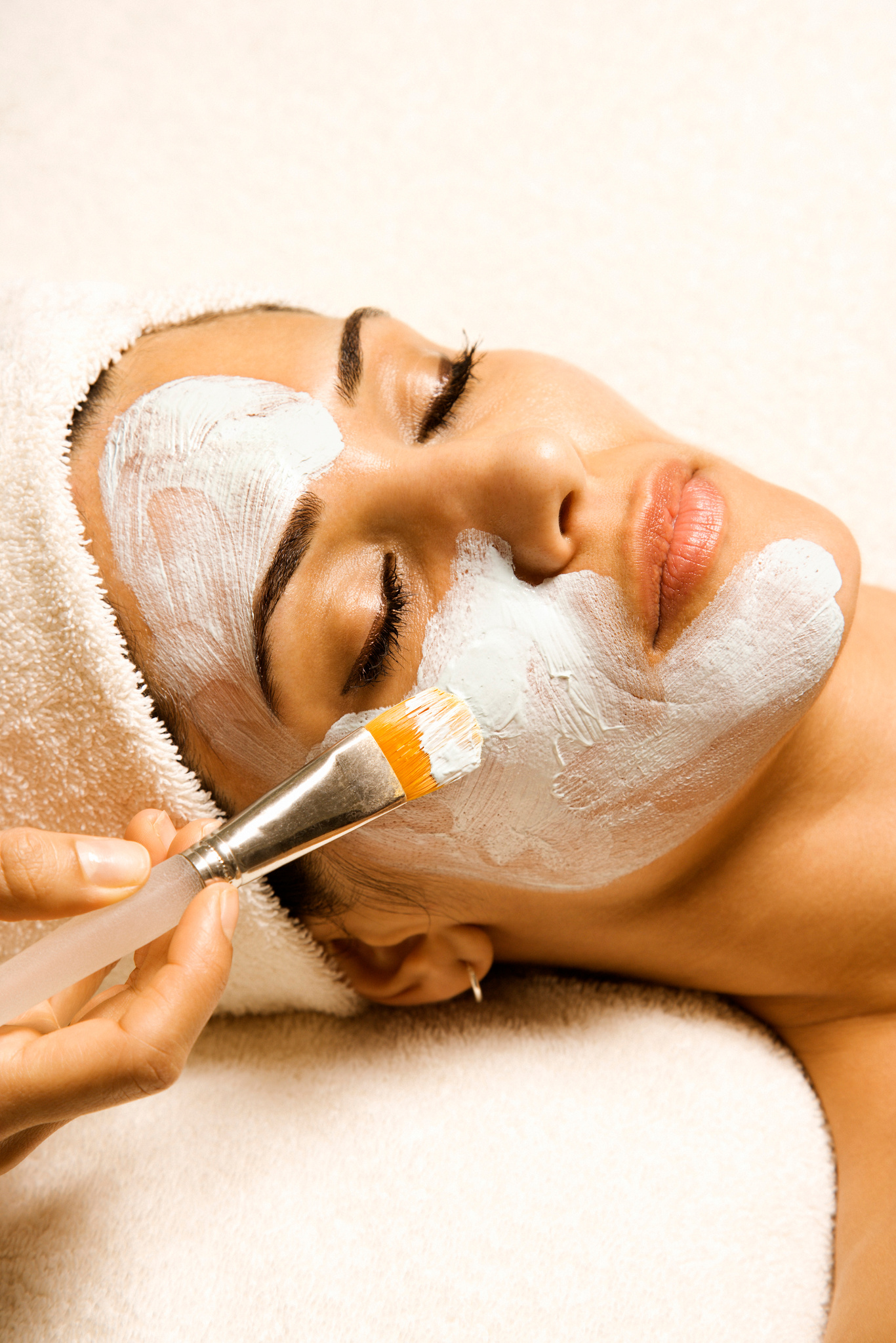 Woman receiving facial treatment at spa